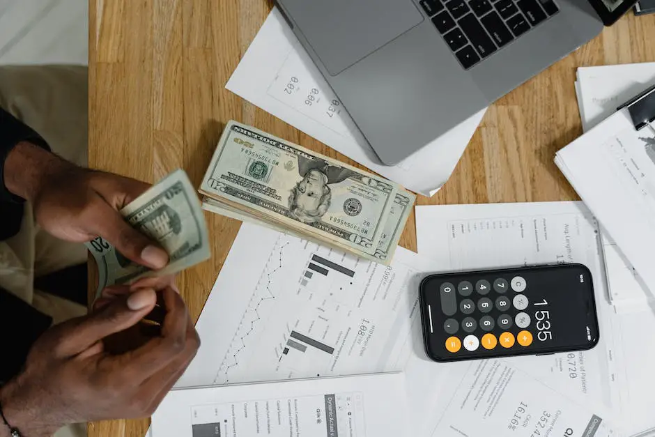A man sitting at a desk with a stack of papers and calculator in front of him as if managing his finances with advice from a financial adviser.