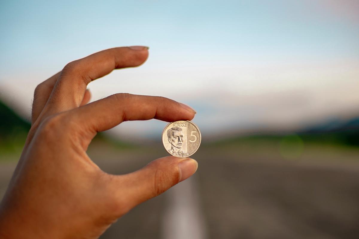 Image of a person holding a coin with the text IRA rollover, representing financial security in retirement.