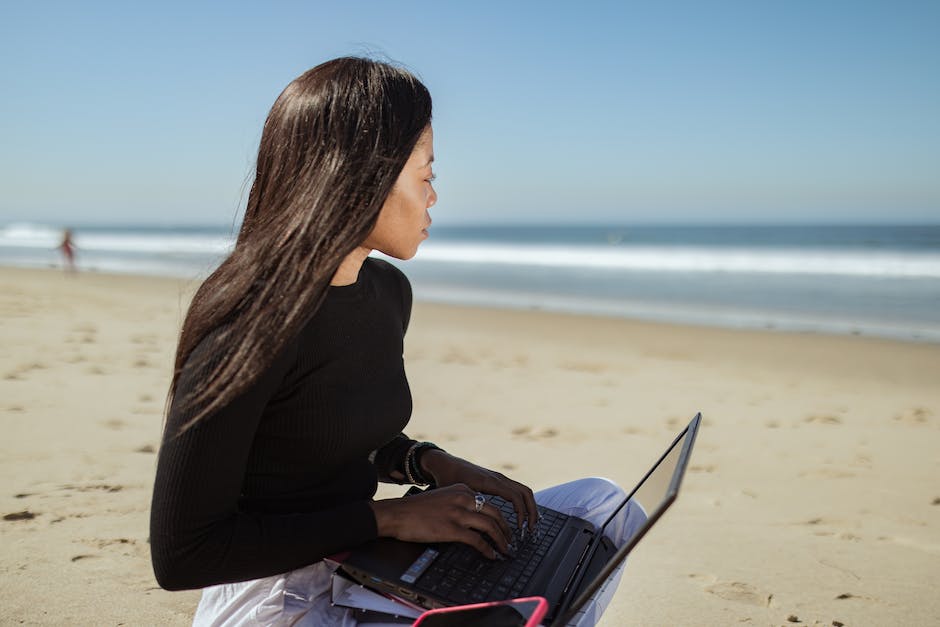 Image of a retiree sitting on a beach with a laptop, representing a secure and comfortable retirement life